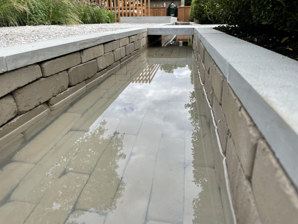 The clay pavers look impressive submerged as part of this water feature. 