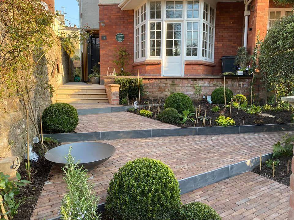 Bexhill Clay Pavers create unique. large steps with surrounding flower beds and natural stone edging. 