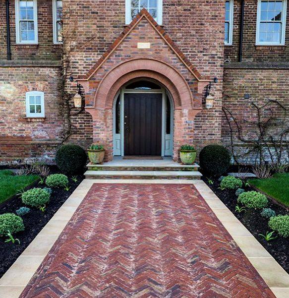 Our Old English clay pavers are used to make a vintage inspired pathway in front of this traditional home. 